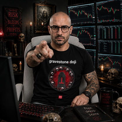 Gothic-style options trader in a dark horror-inspired trading room pointing at the camera while wearing a black gravestone.doji nano.narrative graphic tee surrounded by trading monitors, candles, and skull decor.